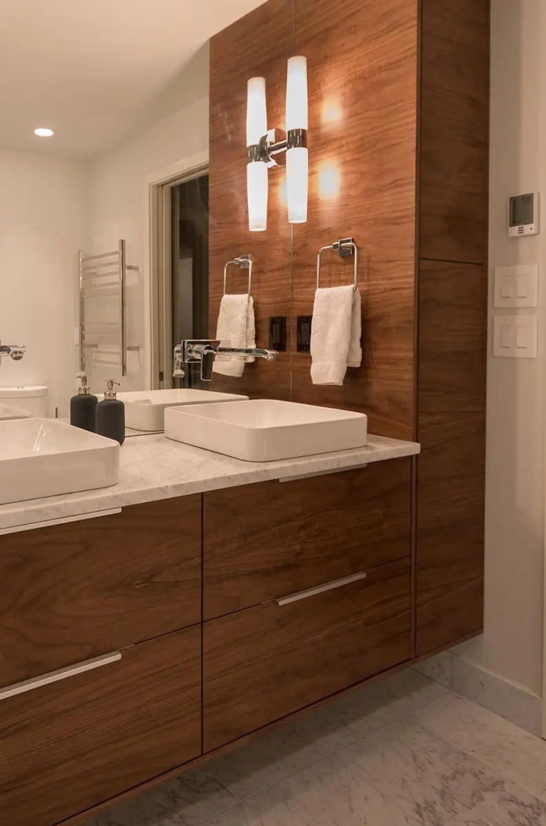 Custom floating walnut vanity with wall-mount faucets