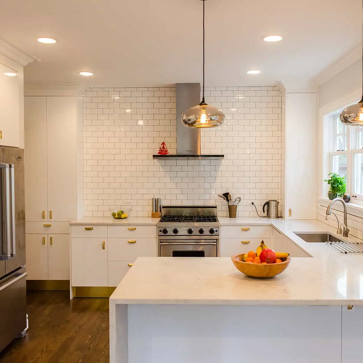 Modern IKEA kitchen with high gloss white cabinets and brass hardware