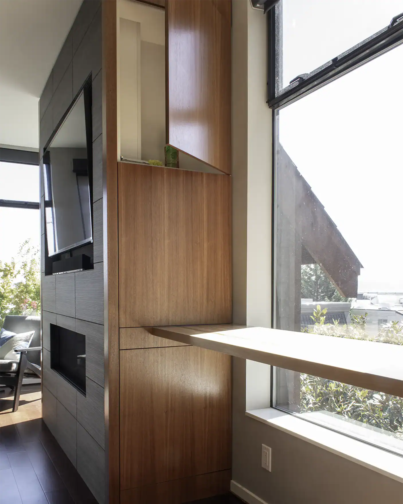 Mahogany cabinets and butcher block bar with tile feature wall