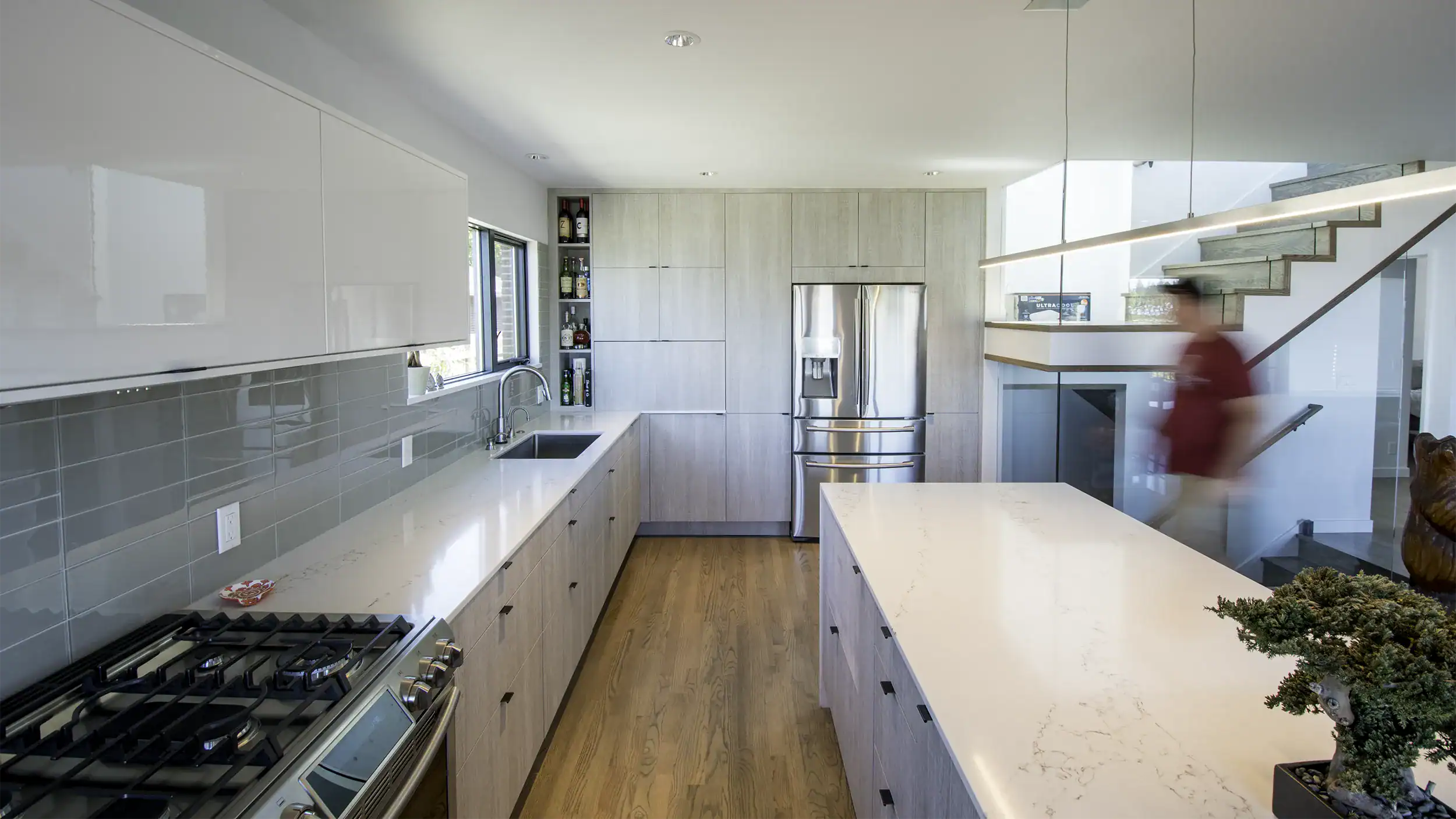 Contemporary IKEA kitchen with grey-and-white cabinets and a waterfall-countertop island, installed in Seattle