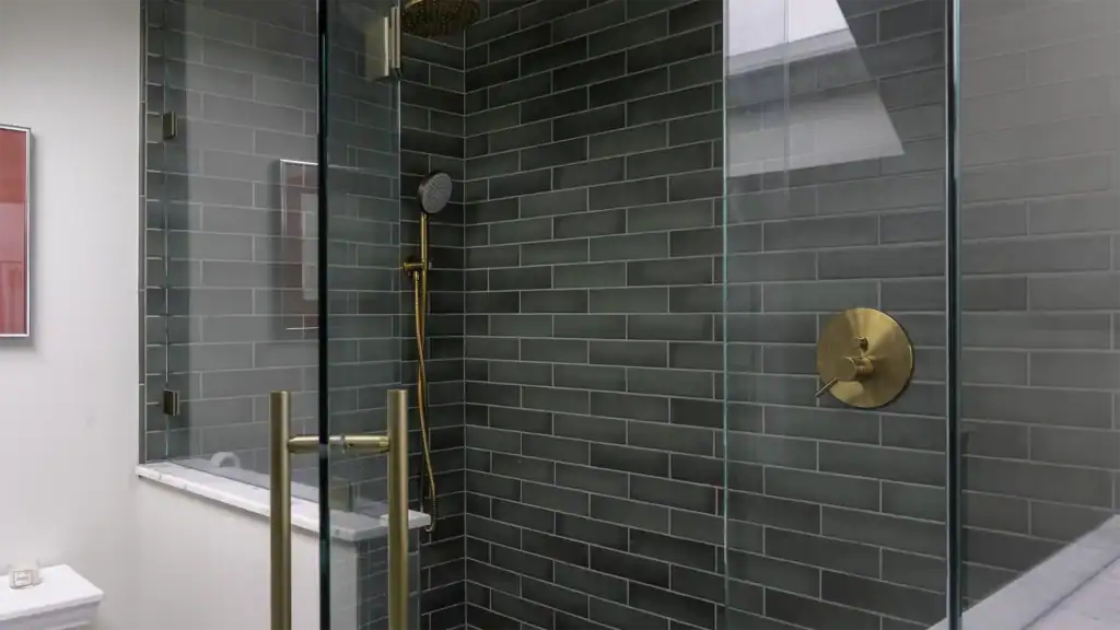 Master bath vanity with marble tile and brass fixtures