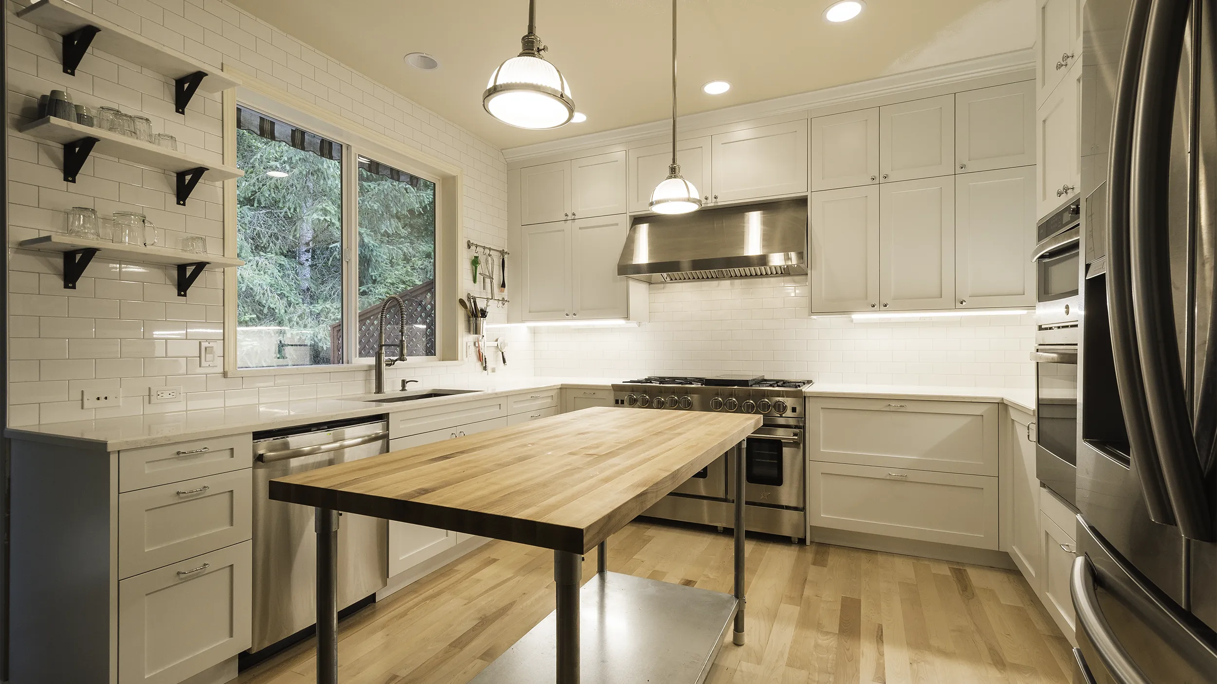 White shaker cabinets installed in a Redmond kitchen remodel, featuring a 48-inch BlueStar commercial-style range
