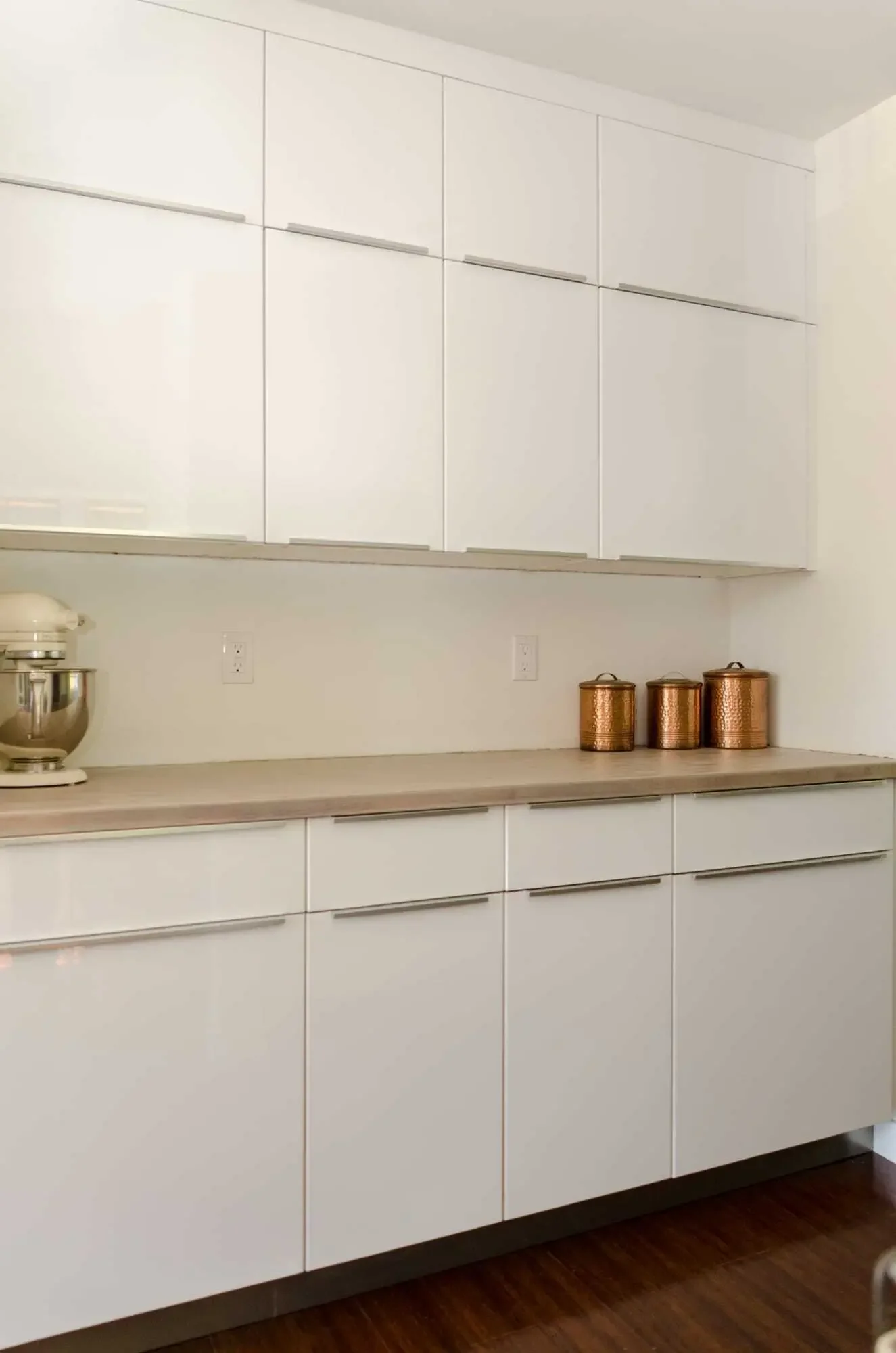 IKEA high-gloss white cabinets for baking station