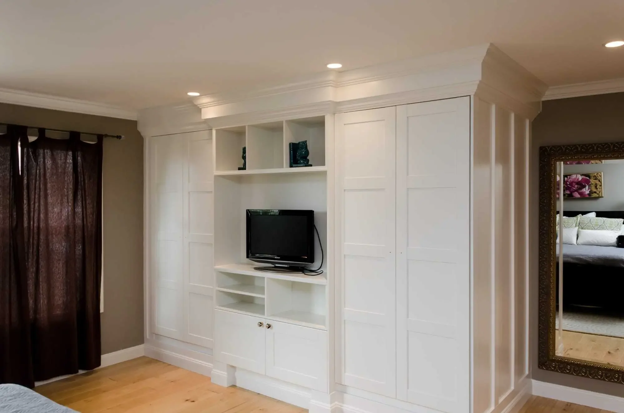 Custom wardrobe built-ins with open shelving media and display