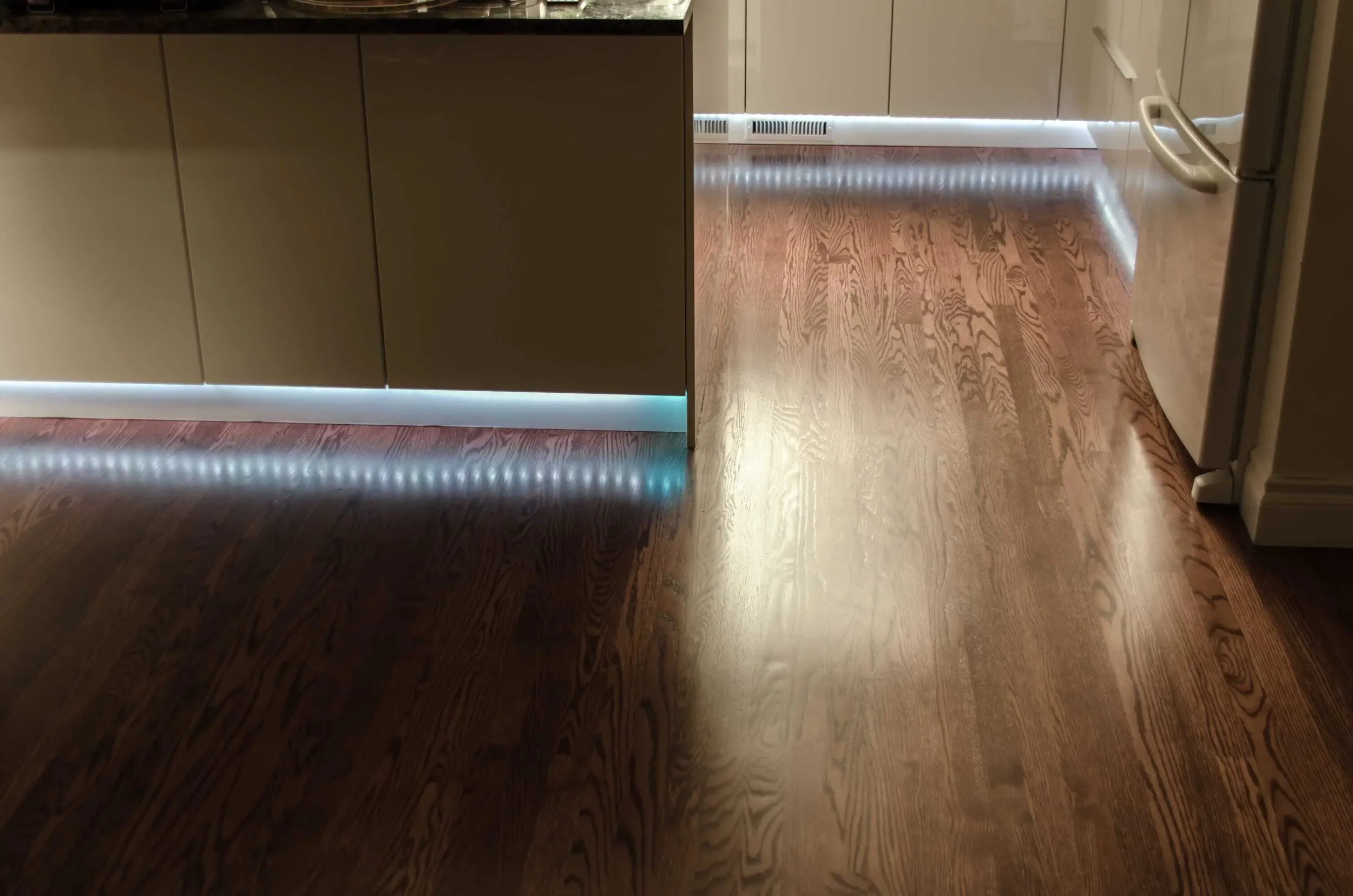 LED light strips installed under toe-kick, activated with motion/light sensor
